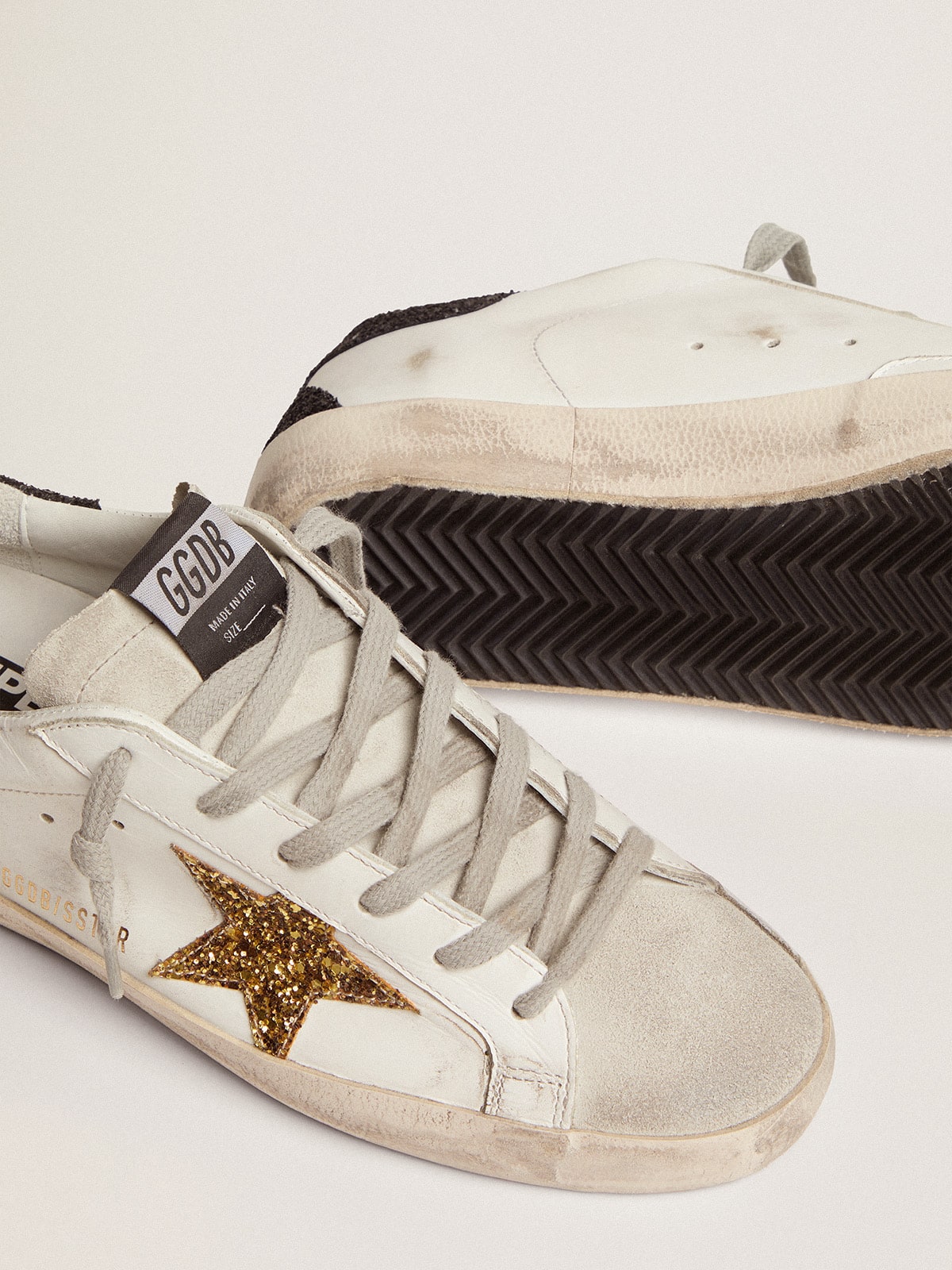 Golden goose in nappa leather with gold glitter star and black glitter heel tab